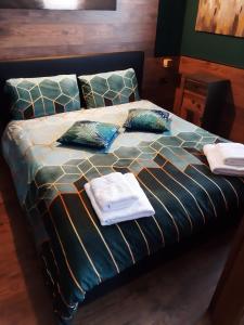 a bed with towels and pillows on top of it at Suite il sogno di Grebek in Passo del Tonale
