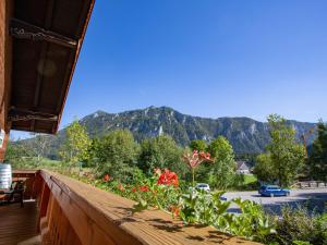 a balcony with a view of a parking lot and mountains at Gästehaus Madsack - Chiemgau Karte in Inzell