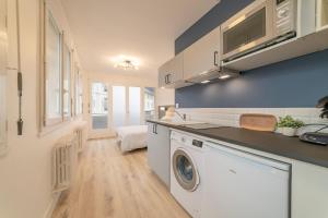 a kitchen with a washer and dryer in a room at apparthotel-gare-chambery in Chambéry +12 photos