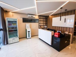 a kitchen with a refrigerator and a counter at HUB Hotel in Teresina