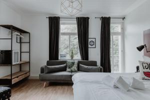 a living room with a bed and a couch at Hotel Palmenbad in Kassel