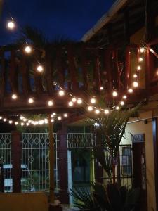a string of lights on a building at night at Hotel BAHÍA in Tela
