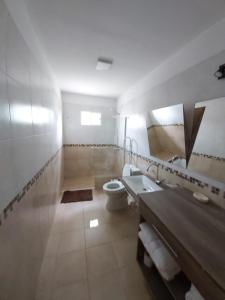 a bathroom with a toilet and a sink and a mirror at By Muni Apartamentos Premium in Tanti +33 photos