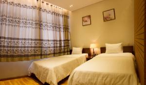 Postel nebo postele na pokoji v ubytování Anh Dao Mekong Hotel