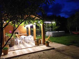 a backyard patio with a pergola at night at Sweet Home Near Black Sea in K'obulet'i