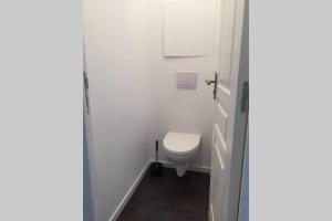 a bathroom with a toilet in a white room at APPARTEMENT T2 in Saint-Brieuc