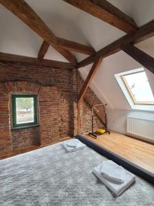 a loft bedroom with a bed and a window at dasHaus in Cisnădie
