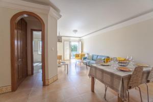 a living room with a table and a couch at Rio Gilao in Tavira