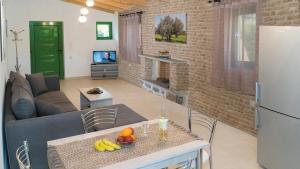 a living room with a couch and a table with fruit on it at Villa Elia in Lambiní