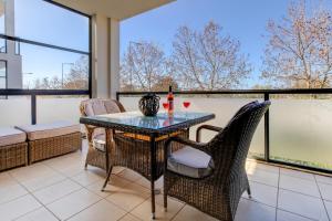 a dining room with a table and chairs and windows at One Bedroom Apartment in Albur Village 1C in Alvor