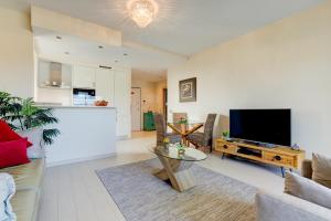 a living room with a couch and a tv and a table at One Bedroom Apartment in Albur Village 1C in Alvor