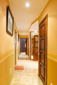 a hallway with yellow walls and an open door at Рыбальская 8 in Kyiv