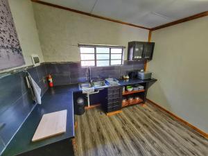 a kitchen with a counter and a sink in a room at The Elements in Graskop