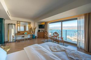 a bedroom with a bed and a balcony with a view at Casa Margot Hotel - Adults Only in Fethiye