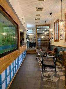 a lobby of a restaurant with tables and chairs at Ristorante Locanda Milano in Gambolò