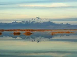 a mountain reflection in the water with a mountain in the background at Sultan Pansion Bird Paradise in Ovaciftlik