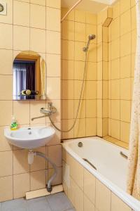 a bathroom with a tub and a sink and a shower at Квартира по улице Большая Васильковская, 114 in Kyiv