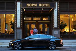 a black car parked in front of a hotel at NOPSI Hotel New Orleans in New Orleans