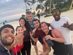 a number of people posing for a picture on a beach at ECOHOSTAL Dorms mixt Dormitorios in Punta Cana