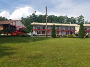 a large building with a grass field in front of it at Econo Lodge Inn & Suites Lake Harmony - Pocono Mountains Area in White Haven