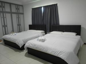 Cama ou camas em um quarto em Klebang Besar Townlodge