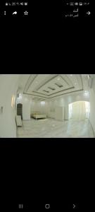 a large room with two couches and a table at فلة ايكيا in Sohar