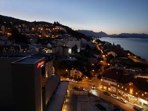 a view of a city at night at CONDOR STUDIO BARILOCHE in San Carlos de Bariloche