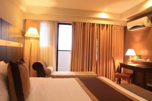 Krevet ili kreveti u jedinici u okviru objekta The Pinnacle Hotel and Suites