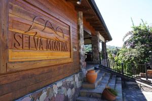 a building with a sign that reads save mountain at Hotel Selva Montana in San Lorenzo