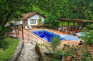 a swimming pool in front of a house at Hotel Selva Montana in San Lorenzo