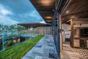 an external view of a house with a balcony with grass at Minh Boutique in Danang