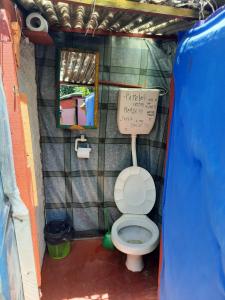 a small bathroom with a toilet in a play house at Ajo Aloha Hostel in Cabo Polonio