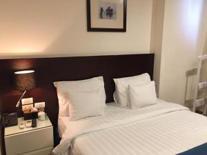 a bedroom with a bed with white sheets and pillows at A25 Hotel - 66 Trần Thái Tông in Hanoi