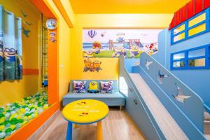 a childrens room with a slide and a table at Han Tian Slide in Wujie