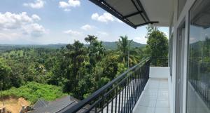 a balcony with a view of the jungle at Raveendra Inn in Kalpetta