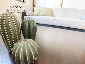 a living room with a couch and a cactus at OUCHI HOTEL Dambara in Hiroshima