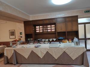 a large kitchen with a table with food on it at Il Nocchiero City Hotel in Soverato Marina