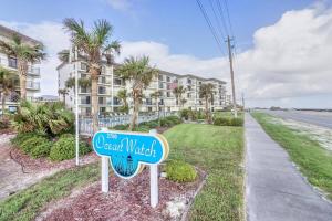 a sign in front of a beachwatch apartment building at Ocean Watch Condo Unit #105 in Ormond Beach