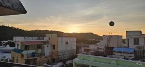 a balloon is flying over a city at sunset at Sai Pavilion in Puttaparthi