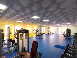 a gym with a lot of treadmills and machines at KeyHost - Minimalist 1BR - Dubai Sports City - K1020 in Dubai