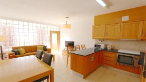 cocina y sala de estar con sofá y mesa en Terraços do Mar 46- Clever Details, en Vilamoura