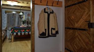 a door with a coat hanging on a wall at Casutele Bunicii in Ocna Şugatag