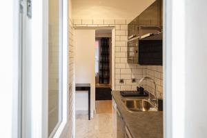 a kitchen with a sink and a counter at NEAR EIFFEL TOWER - BEAUTiFUL FLAT in Paris