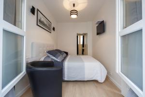 a white bedroom with a bed and a window at NEAR EIFFEL TOWER - BEAUTiFUL FLAT in Paris +15 photos