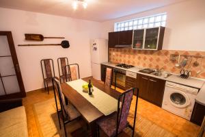a kitchen with a dining table and a kitchen with a stove at Villa Townhouse 36 Sibiu in Sibiu