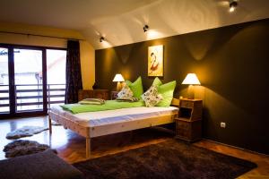 a bedroom with a bed with green pillows at Villa Townhouse 36 Sibiu in Sibiu