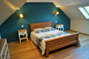 a bedroom with a bed and two night stands at Les Chambres de Saint Hilaire in Saint-Hilaire-Cottes