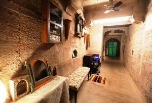 a hallway with a bench in a stone wall at Casa De Jodhpur in Jodhpur