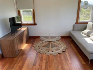 a living room with a couch and a coffee table at Jetty's End Bicheno in Bicheno