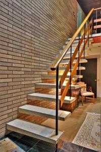 a staircase in a room with a brick wall at Unique and Secluded Country Estate near Pittsburgh in Weirton